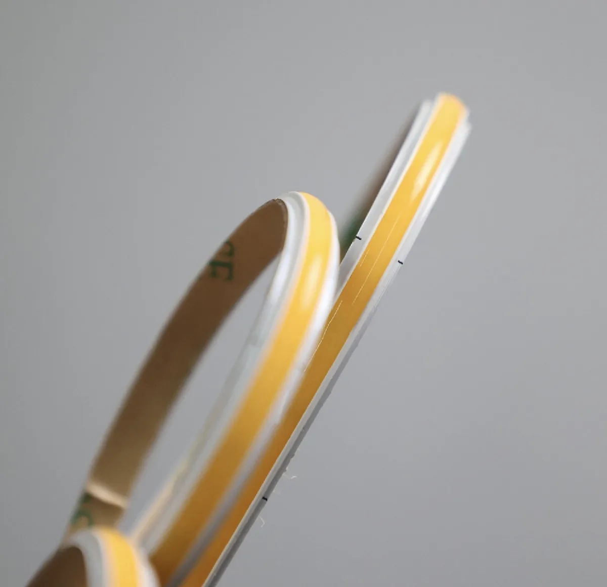 DAM-ART COB LED strip showing the raised barrier walls on each side of the phosphor line