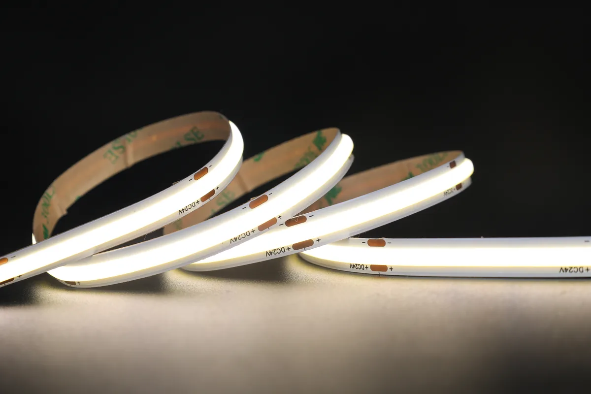 Close-up of a lit COB LED strip coiled on a dark surface