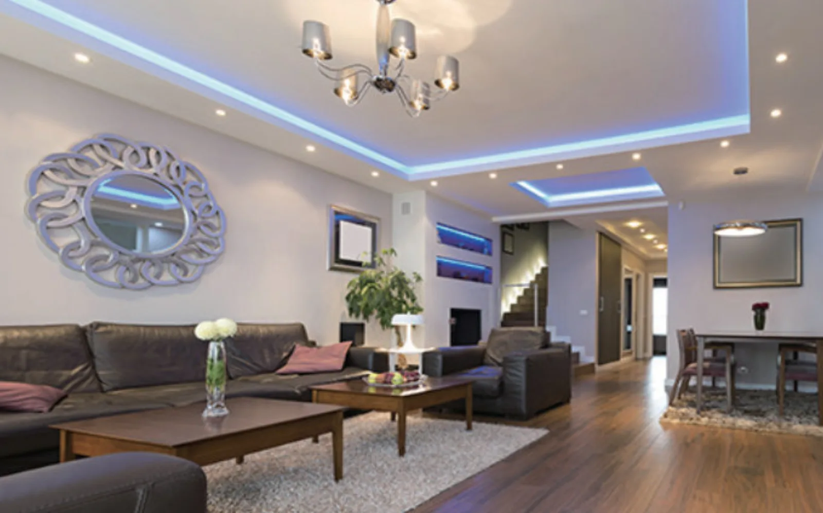 Living room with an LED cove lighting the edge of a tray ceiling